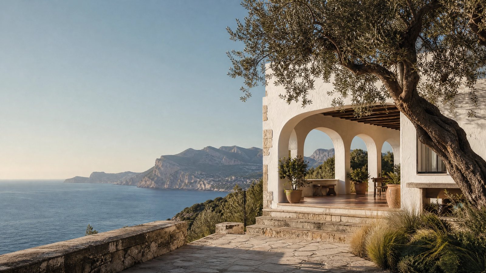 Mediterranean villa above a blue Spanish bay